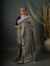 ANAYA - Grey linen cotton jamdani saree with white borders and white and pink motifs on the body and pallu